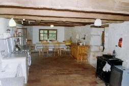 There is a large farmhouse table in the kitchen