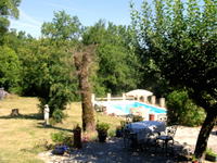 The patio has plenty of shade from an apple tree