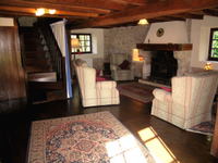 The living room with stone walls and oak beams