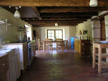 There is a large farmhouse table in the kitchen