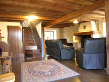 The living room with stone walls and oak beams